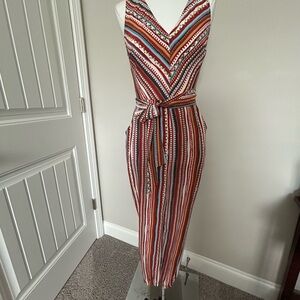 LUSH Orange Multi-Print Jumpsuit. New W/O tags. Small. Great fabric for travel!